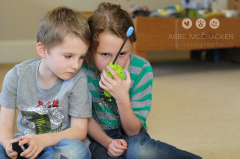 children playing together inside with walkie-talkie