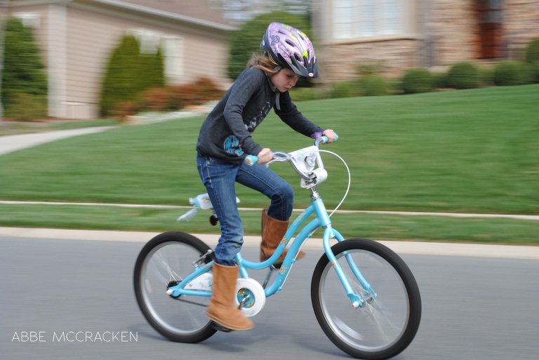 child riding her bike, panning technique used