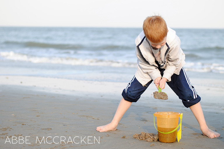 school boy shoveling beach sand at Isle of Palms, SC during Spring Break