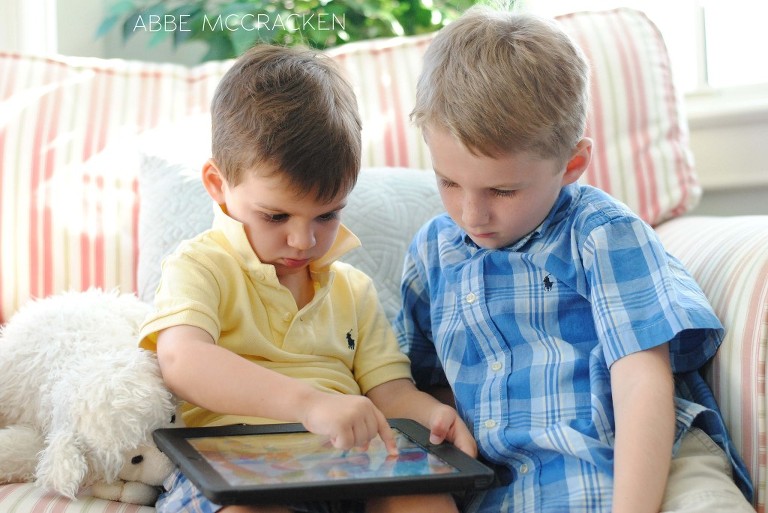 friends playing an iPad in Wild Dunes rental home, Isle of Palms
