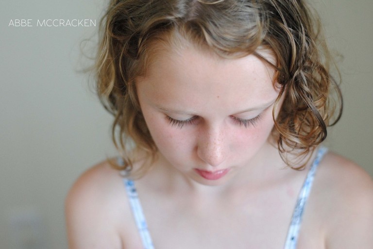 girl with gorgeous curls, eyelashes and freckles