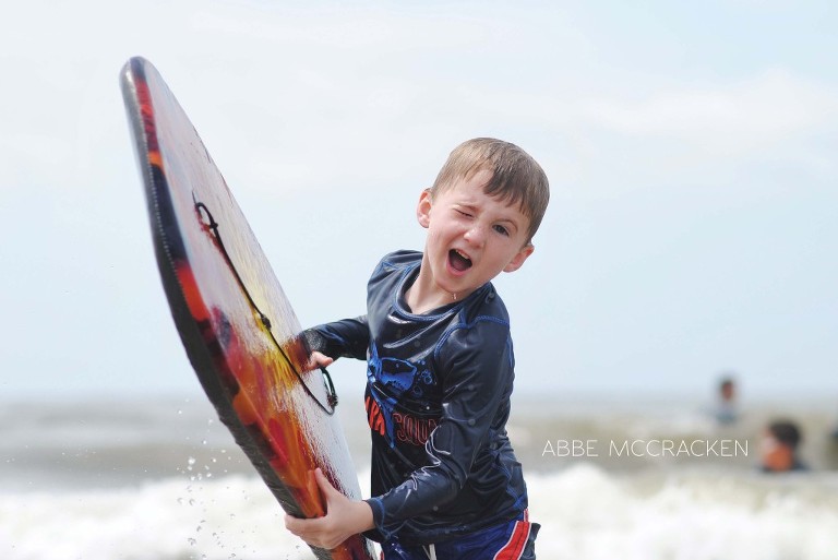 child coming out of the surf with boogie board, Isle of Palms