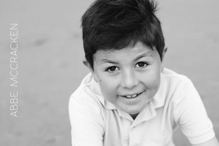 boy in black and white on the beach