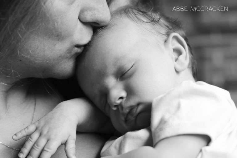 tender moment between mother and newborn son