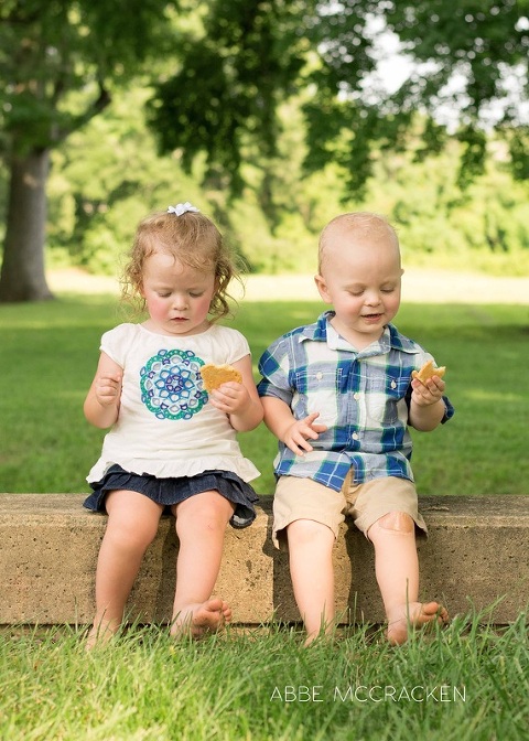 toddler twins eating cookies, mimicking behavior