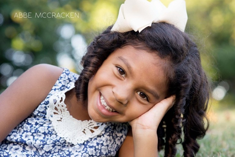 young girl with ringlet curls, big brown eyes