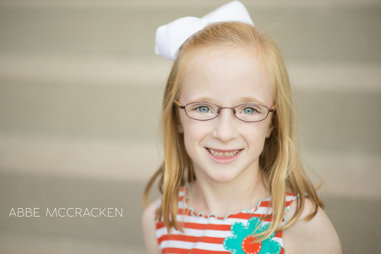 young strawberry blond girl with light skin, glasses