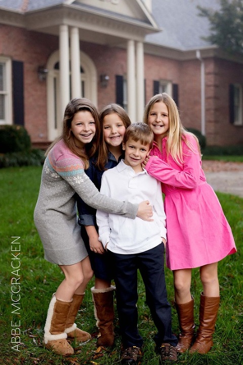 Siblings hugging outside of their South Charlotte home