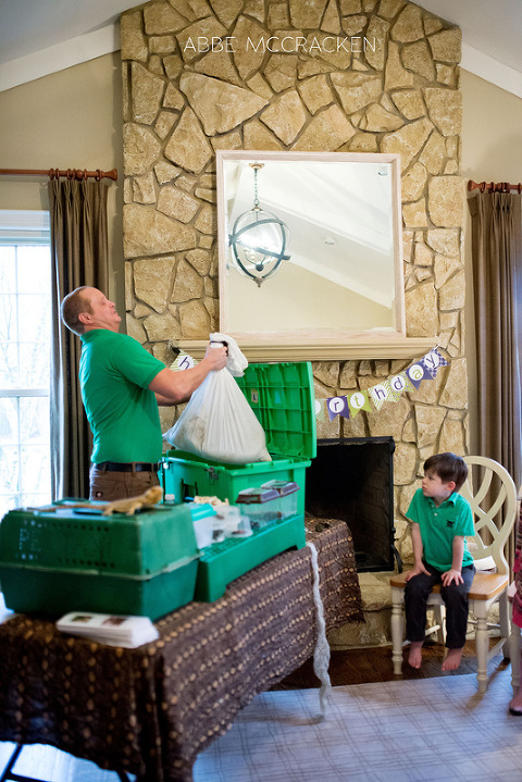 staff member from Cold Blooded Encounters lifts snake out of container for children to see
