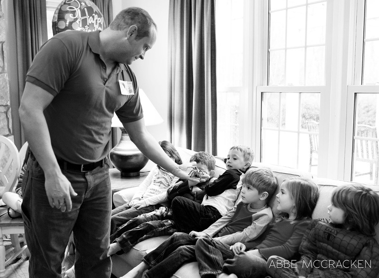 a staff member from Cold Blooded Encounters shows children a tarantula during a birthday party