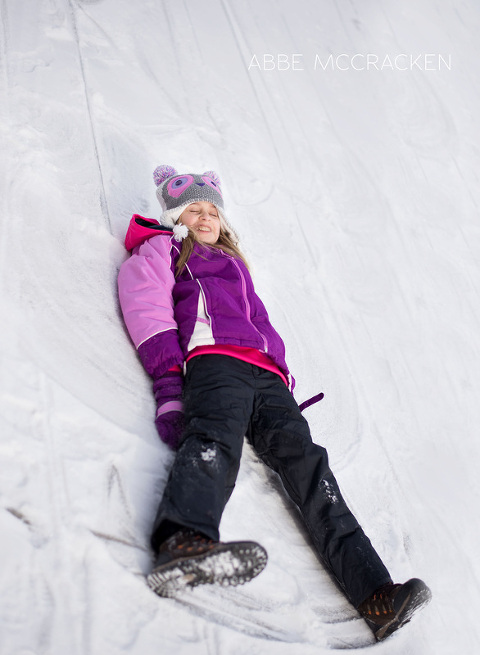 child making snow angels