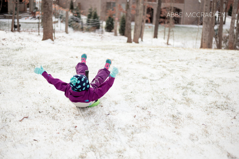 sledding in a small amount of snow