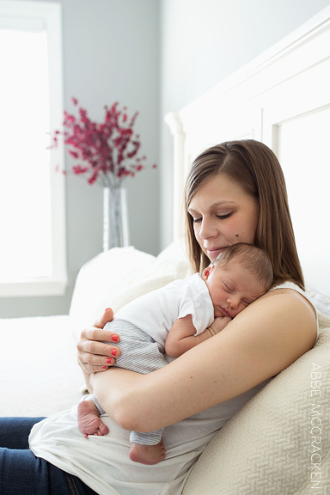 A mother's shoulder is perfect spot for this newborn baby boy