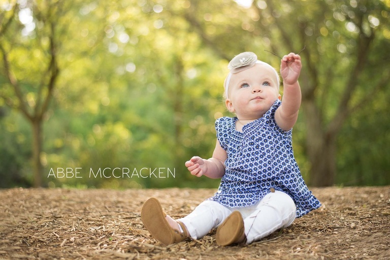 one year old baby girl dressed in blue and white