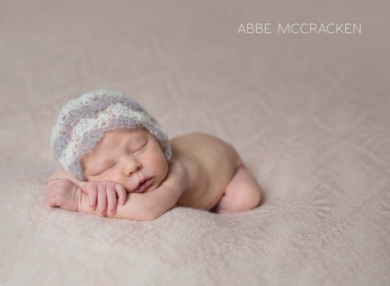newborn baby girl posed on lace blanket