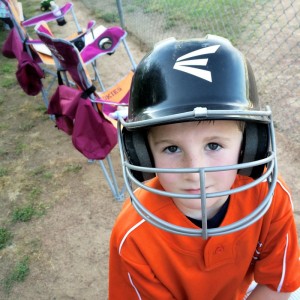 youth baseball player wearing helmet