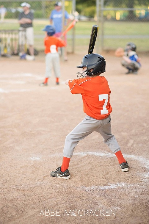 child practicing swing before batting- South Charlotte Recreation Association baseball