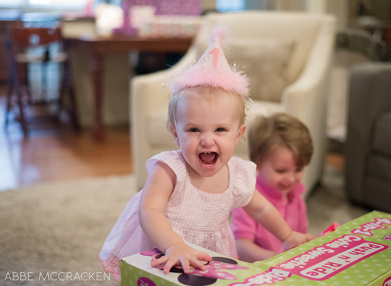 one year old birthday girl opening her presents