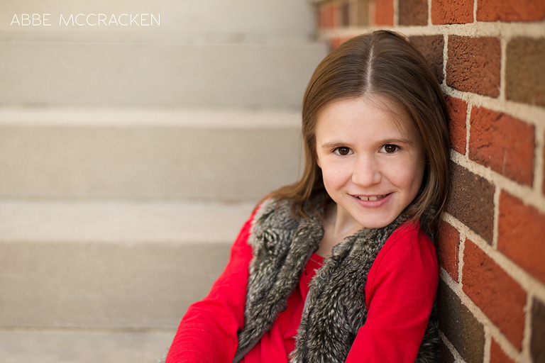 child in red, urban setting