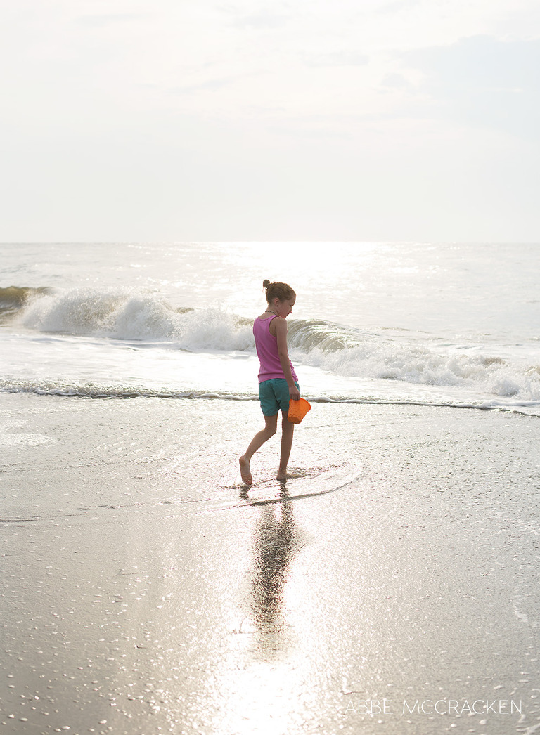 Child exploring early morning tide