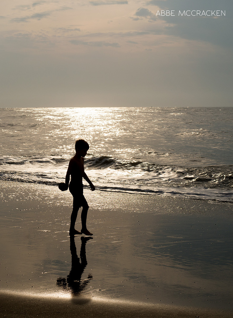 child silhouette on the beach