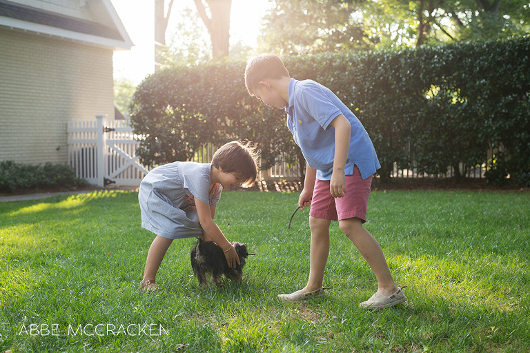children playing with dog during a summer backyard photo session