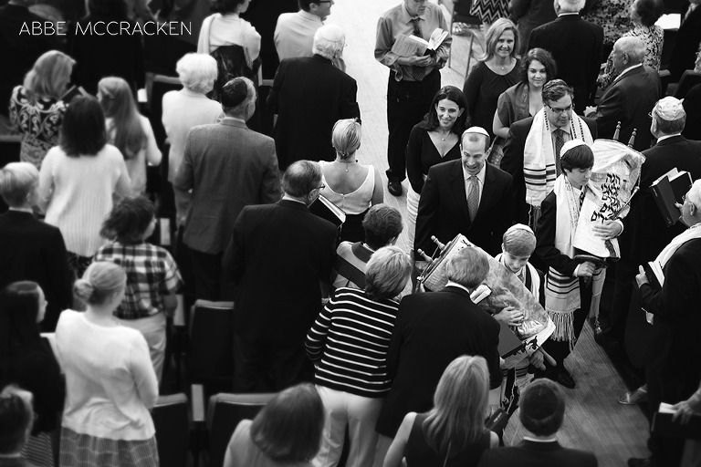family walking down the aisle amongst family and friends at Bar Mitzvah