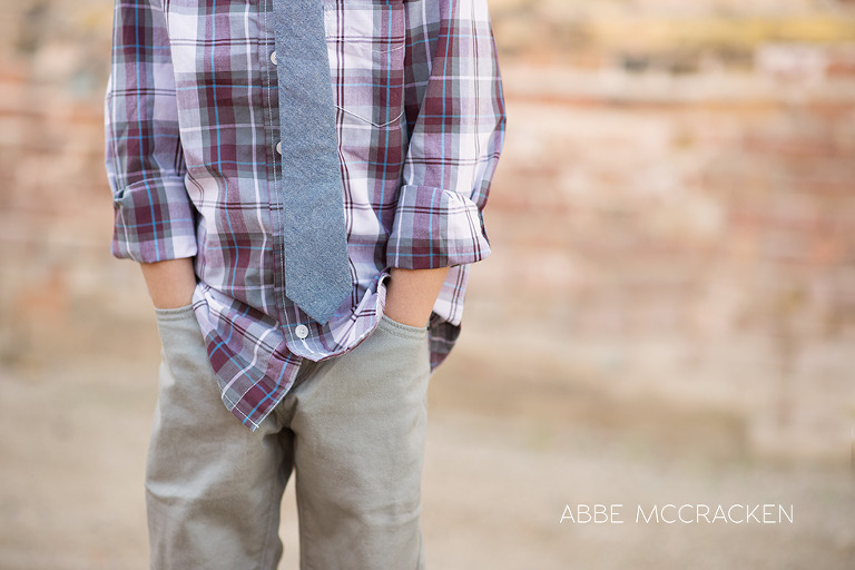one cool kid - boy in urban setting with plaid shirt and blue tie