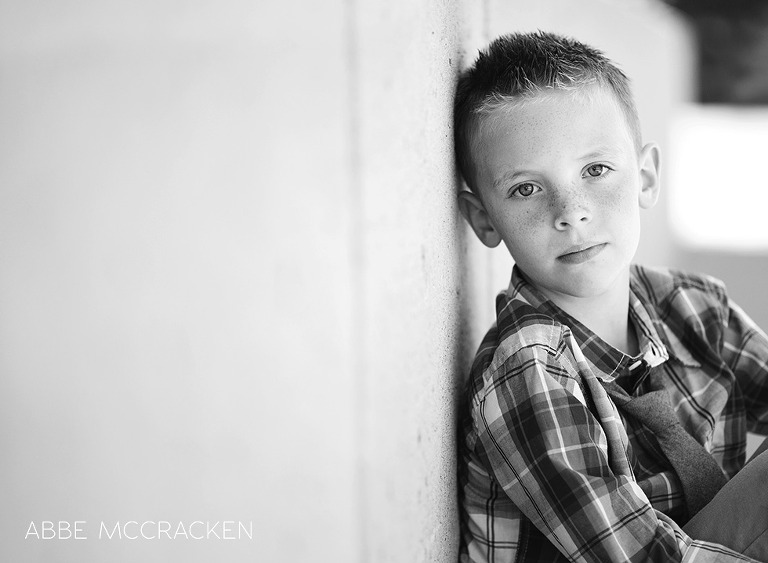 one cool kid - urban boy in black and white leaning against a wall
