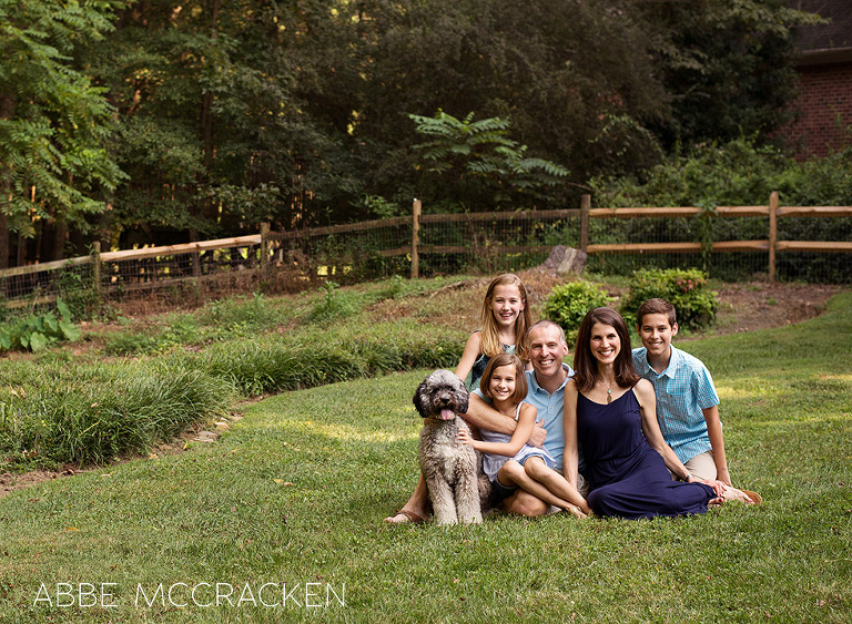 family of five plus the dog posed at home