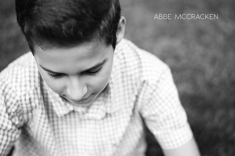 teen boy looking down in black and white