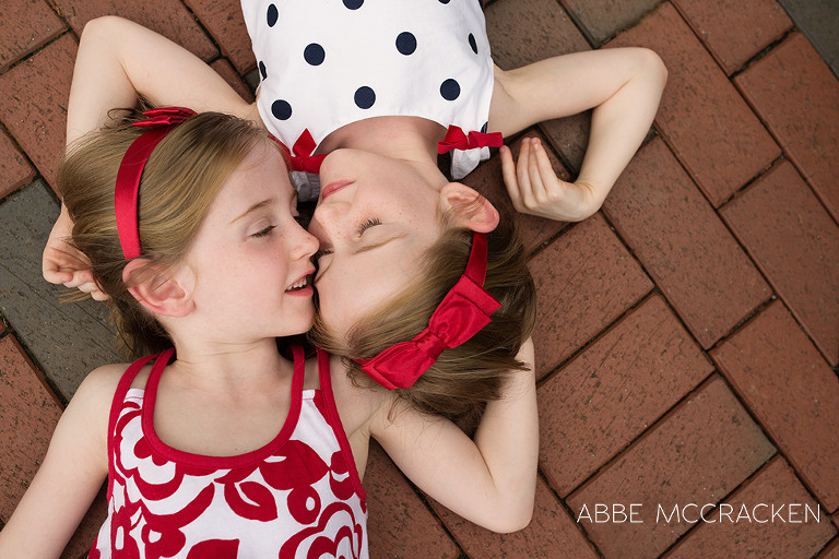 red headed twins laying on bricks