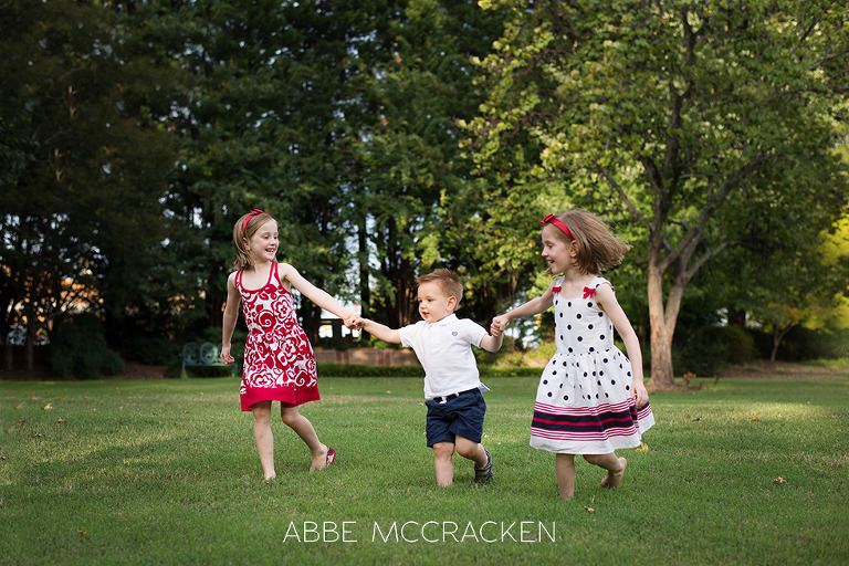 Children running in Stumptown Park - twins with younger brother