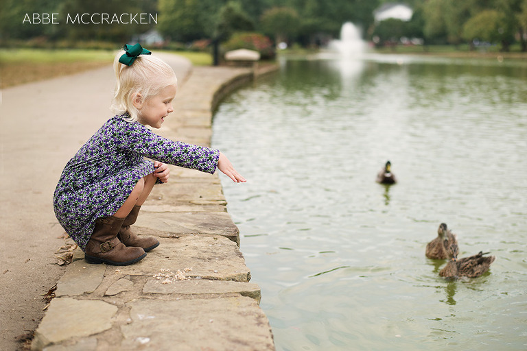 child feeding ducks at Freedom Park