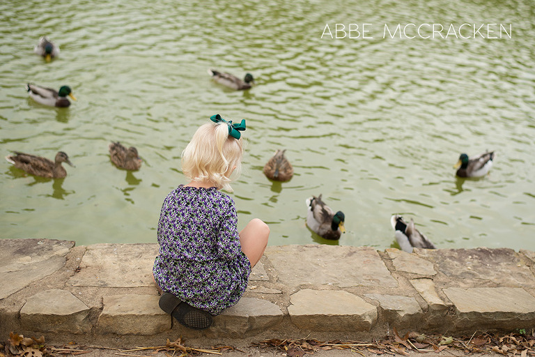 young girl feeding ducks at Freedom Park in Charlotte