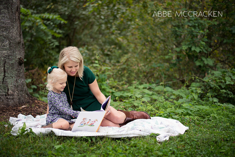 Mother and daughter reading Fancy Nancy in the park