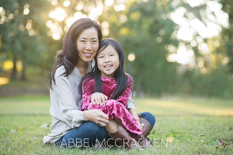 Mother daughter sitting in the grass at Independence Park