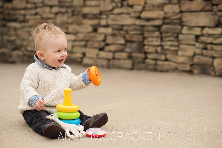 8 month old baby boy pictured playing with his stacking toys