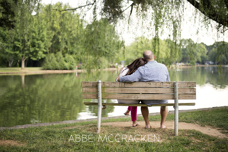 Parents snuggling on a bench in Freedom Park, Charlotte