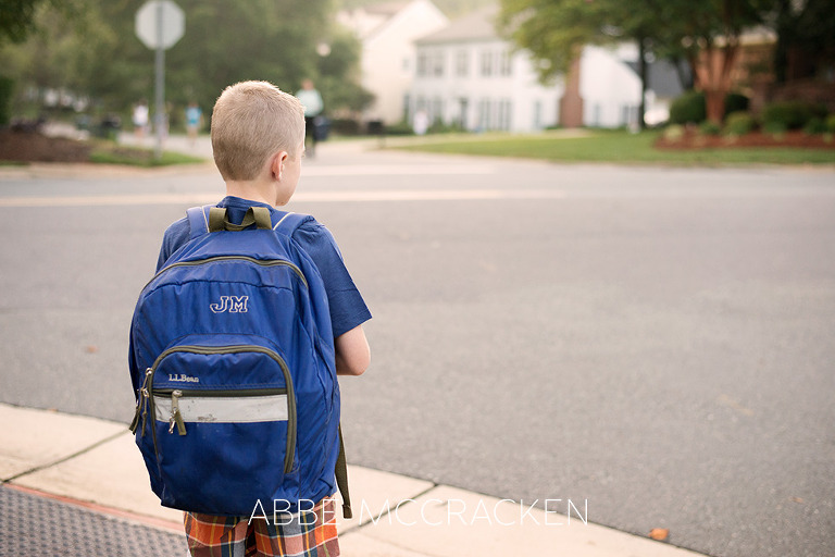 Back to School in Charlotte NC - boy wearing his backpack waiting for the school bus by Abbe McCracken