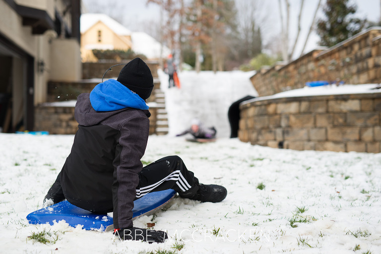 Children sledding in Charlotte NC by Charlotte Childrens Photographer Abbe McCracken