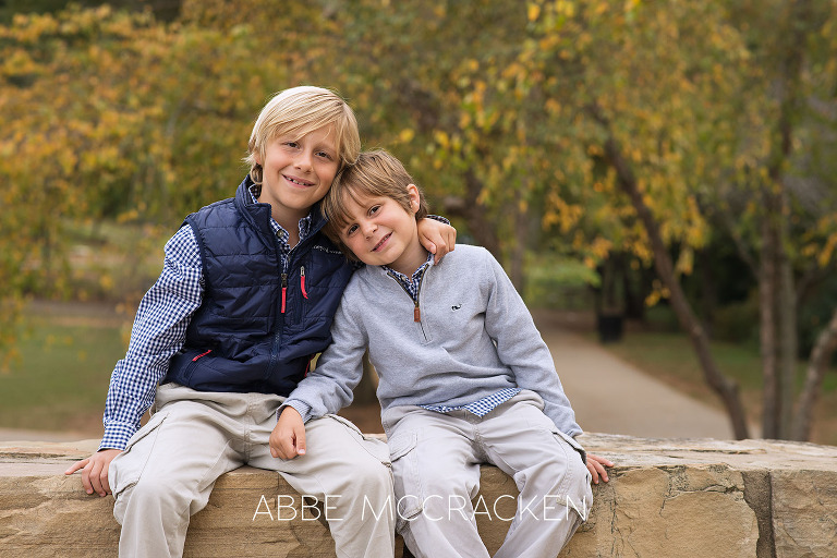 Portrait of brothers sitting on a stone wall in Freedom Park, Charlotte NC