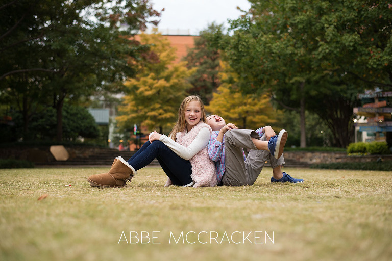 Candid sibling portrait photographed on The Green in Uptown Charlotte