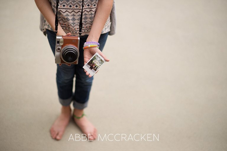 Portrait of a tween girl with a Fuji Instax Mini 90