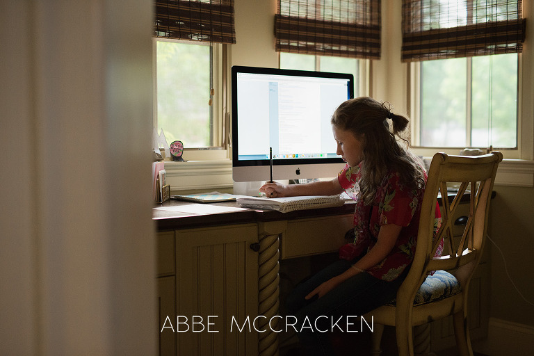 In- home lifestyle moment of a tween girl finishing homework before school