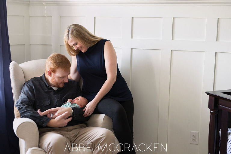 Parents admiring their new baby boy during his at home newborn session