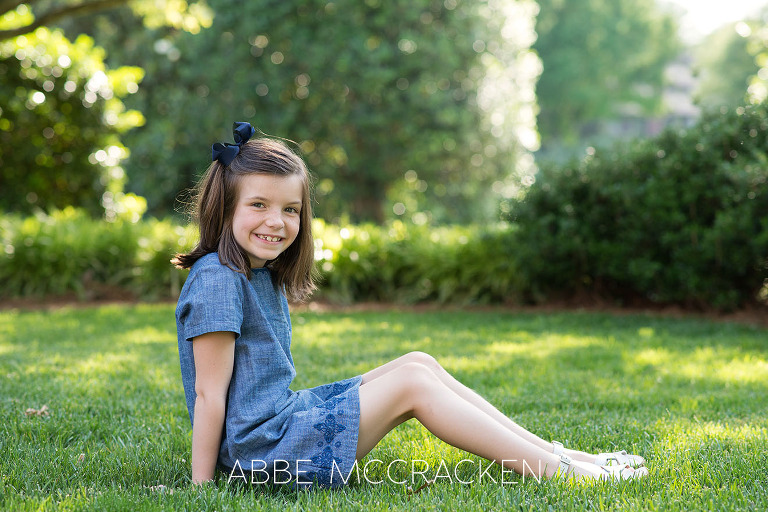 Portrait of a young girl sitting in the grass on the grounds on Carmel Country Club