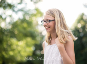 Candid portrait of a young tween girl with sparkly bokeh in background