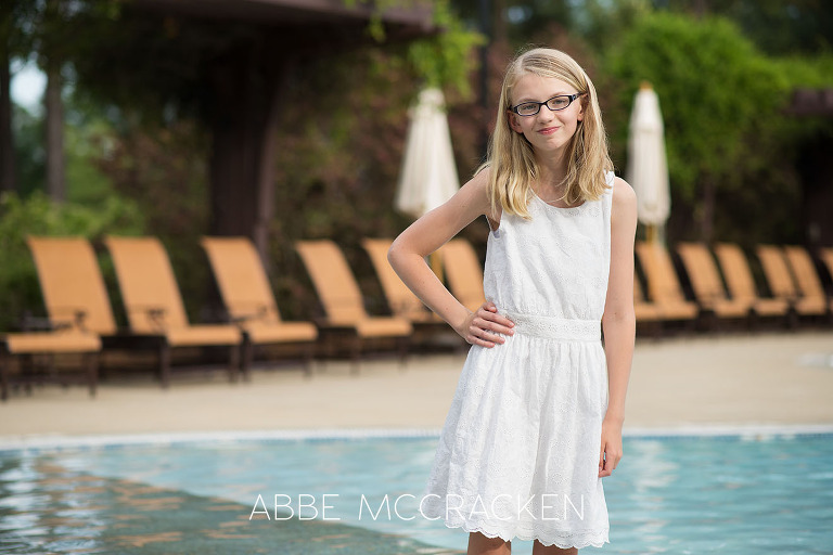 Candid image of a tween girl posing in the Carmel Country Club pool