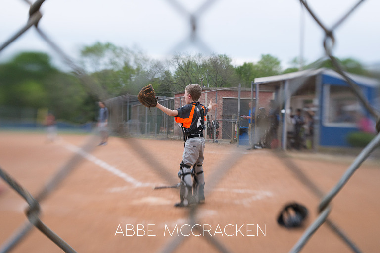 Youth baseball. Lensbaby image with sharp focal point on the catcher's disapproval of the call